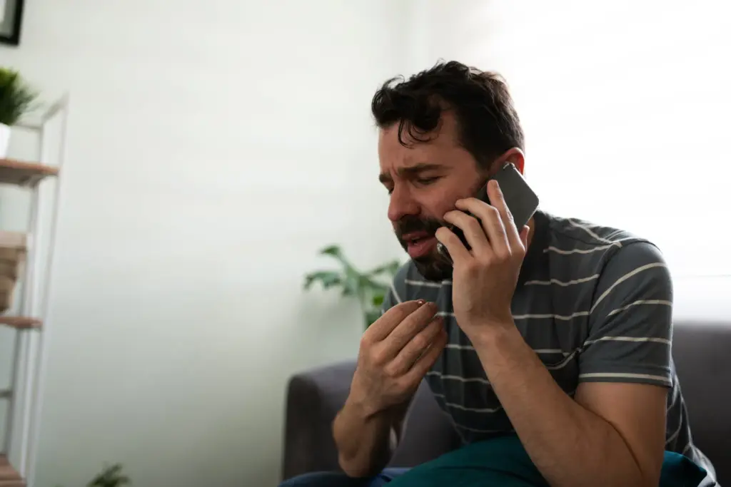 Stressed man talking on the phone