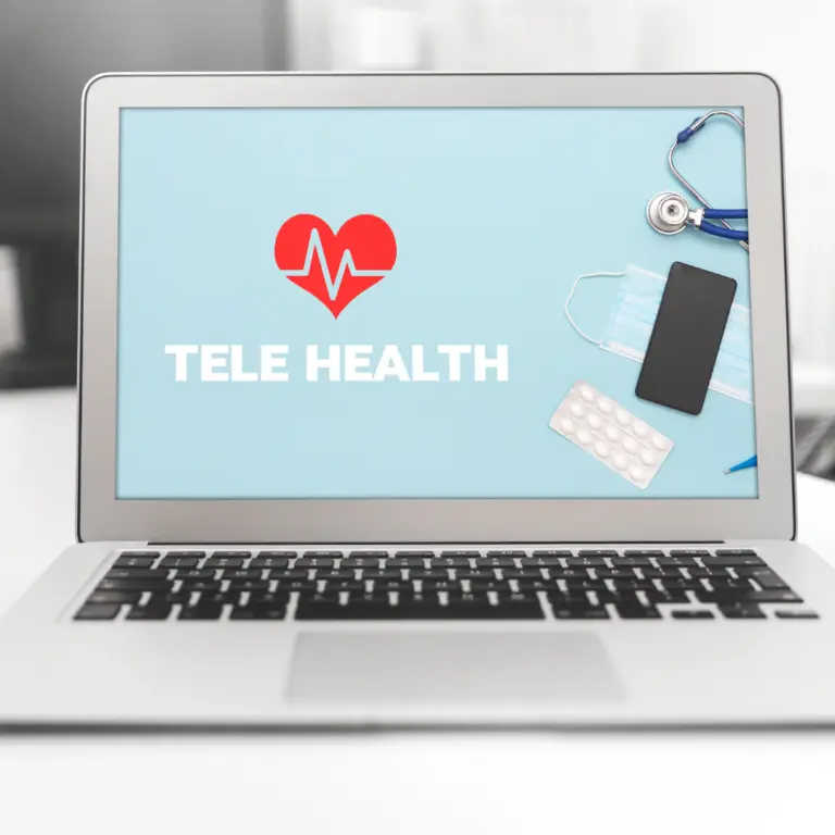 Laptop showing a telehealth screen next to a smartphone