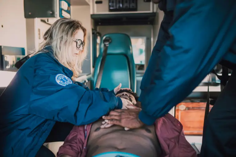 Paramedics caring for a patient in the back of an ambulance